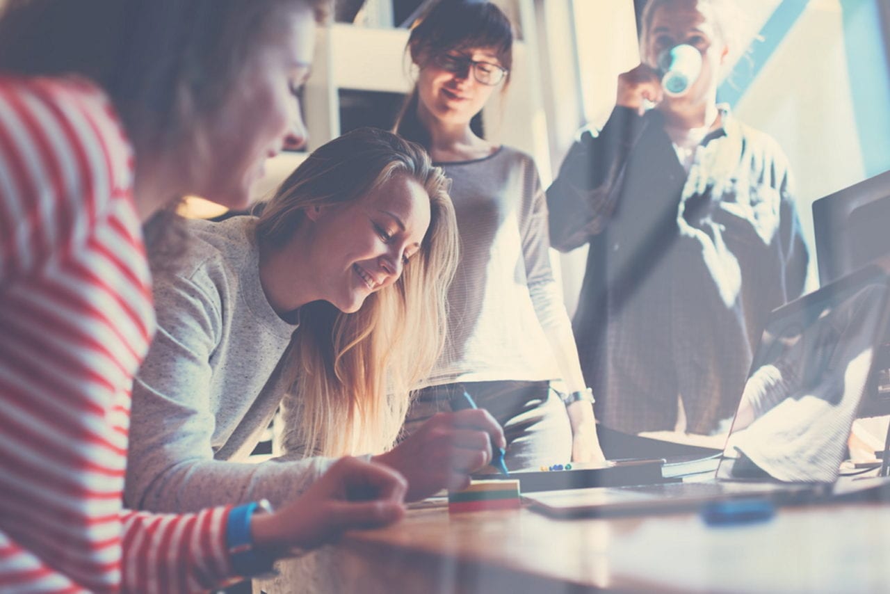 Photograph of students working together on a laptop